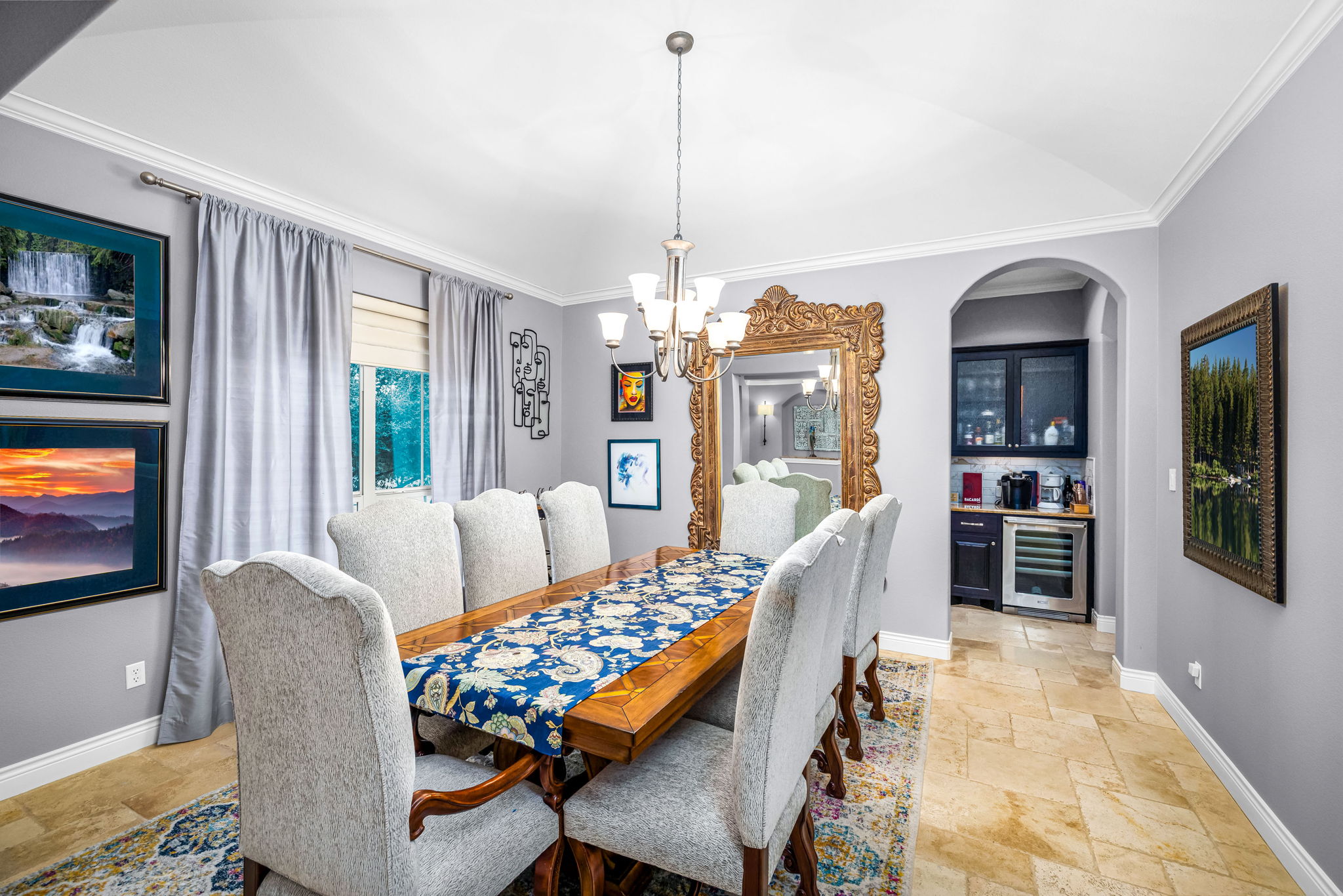 11604 Shoreview Overlook Austin, TX 78732 - Photo 14 of 40 Dining room with ornamental molding, stone tile floors, a chandelier, wine cooler, and vaulted ceiling
