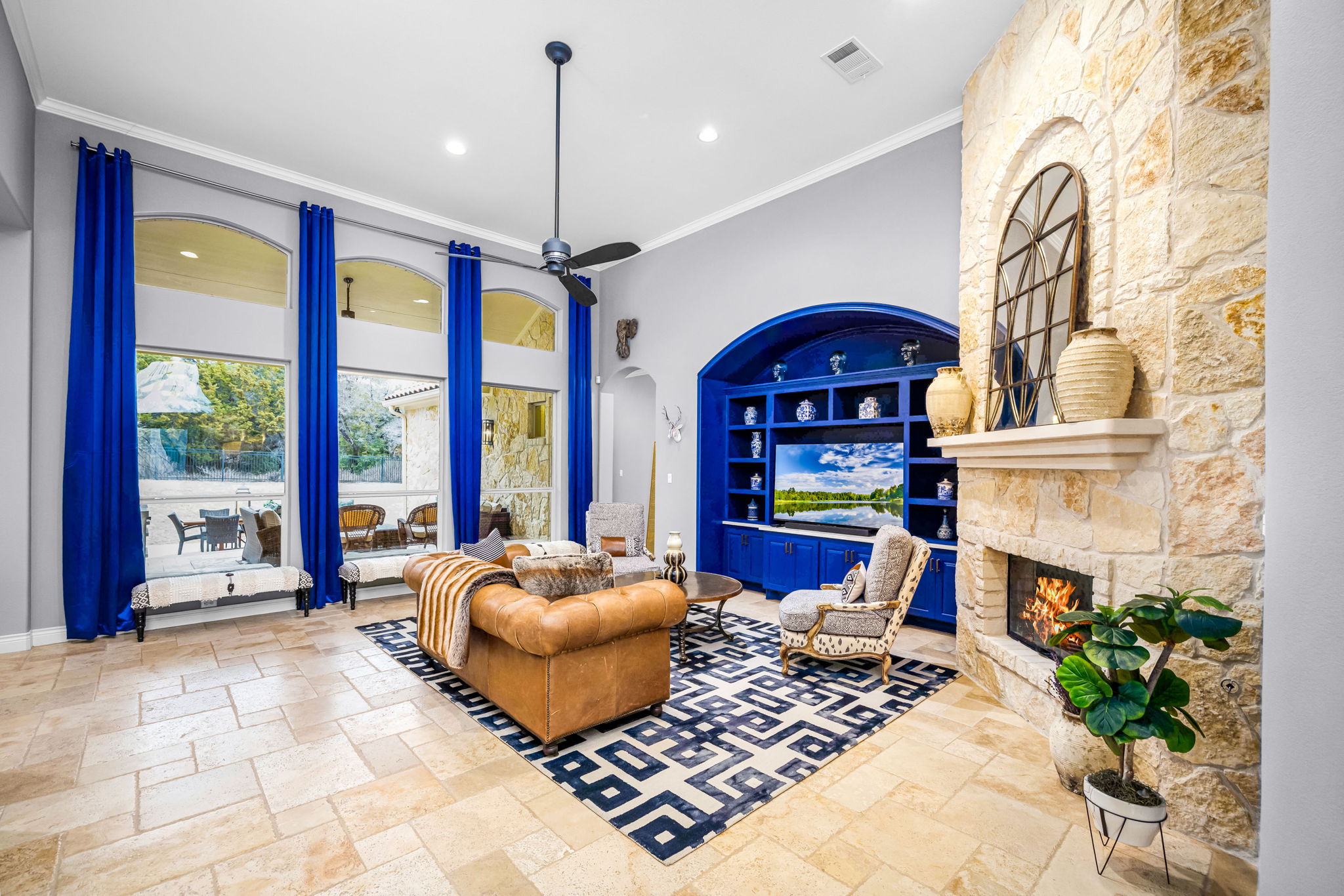 11604 Shoreview Overlook Austin, TX 78732 - Photo 15 of 40 Living room with a fireplace, built in features, recessed lighting, a ceiling fan, and crown molding