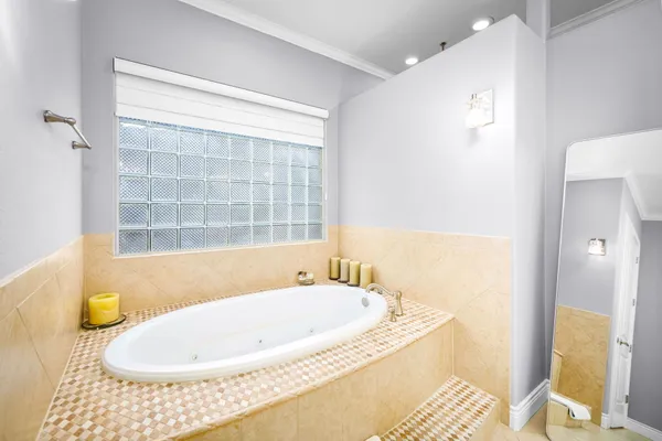 a bathroom with a tub and shower