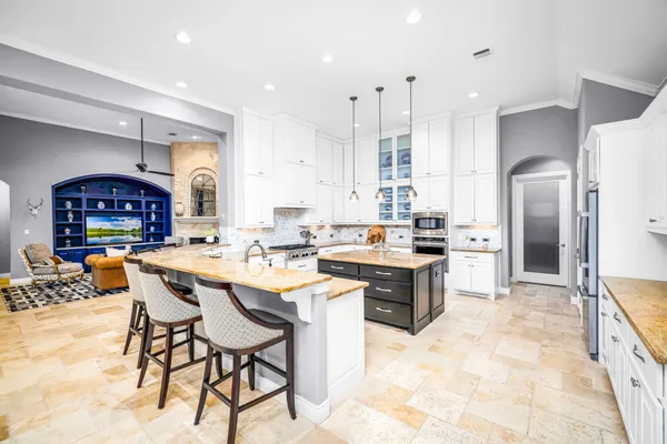 a kitchen with stainless steel appliances kitchen island granite countertop a sink and cabinets