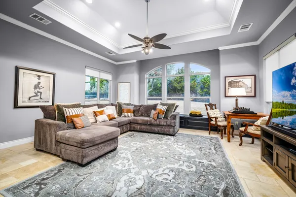 a living room with furniture ceiling fan and a rug