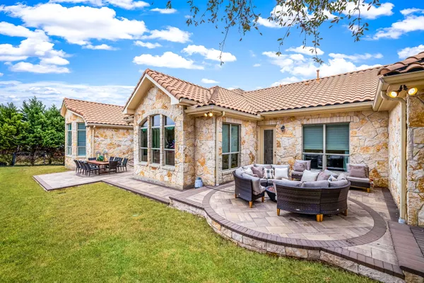 a view of a house with backyard porch and sitting area
