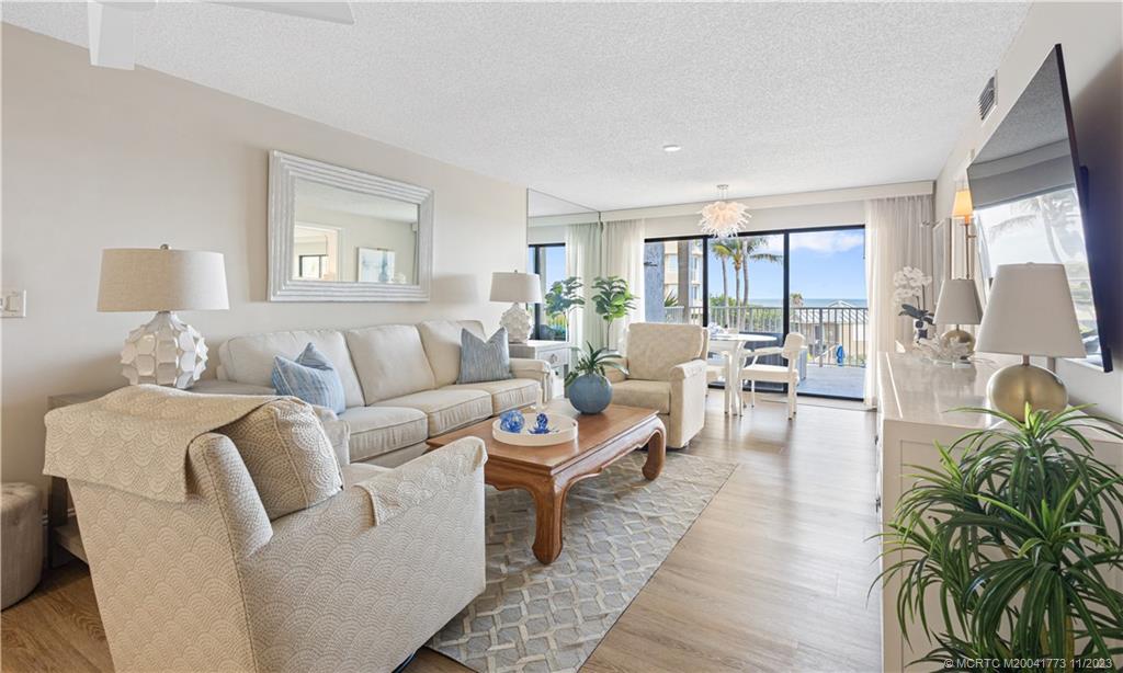 429 Northeast Tradewind Lane, Unit 2109 Stuart, FL 34996 - Photo 13 of 35 a living room with furniture and a large window
