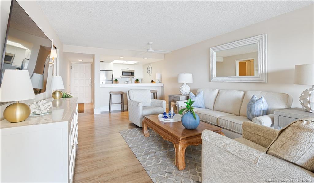 429 Northeast Tradewind Lane, Unit 2109 Stuart, FL 34996 - Photo 14 of 35 a living room with furniture and a wooden floor