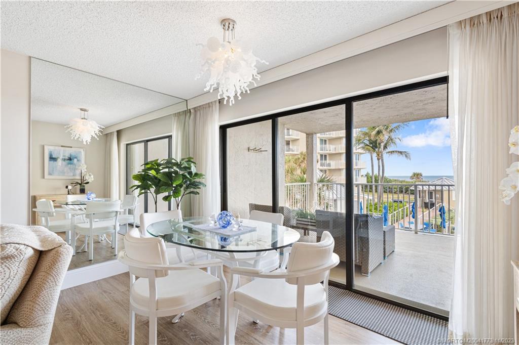 429 Northeast Tradewind Lane, Unit 2109 Stuart, FL 34996 - Photo 15 of 35 a dining room with furniture a livingroom and chandelier