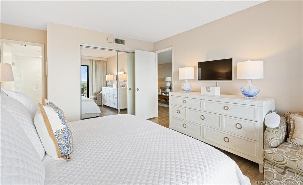 429 Northeast Tradewind Lane, Unit 2109 Stuart, FL 34996 - Photo 21 of 35 a bedroom with a bed and a flat screen tv