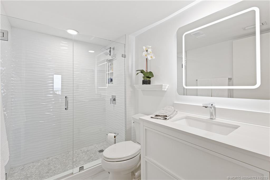429 Northeast Tradewind Lane, Unit 2109 Stuart, FL 34996 - Photo 22 of 35 a bathroom with a sink toilet and shower