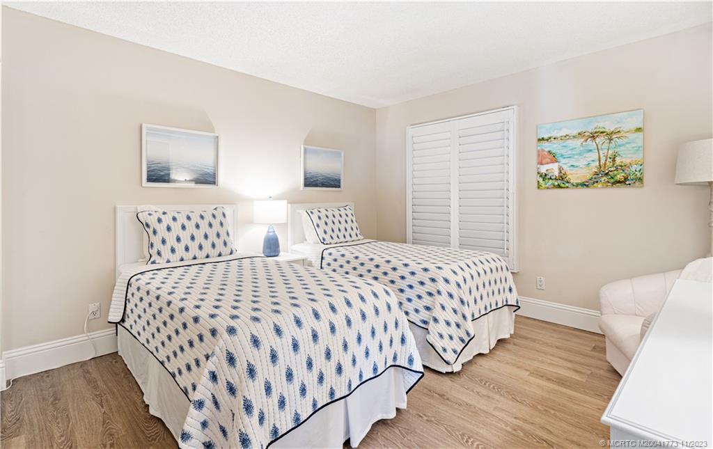 429 Northeast Tradewind Lane, Unit 2109 Stuart, FL 34996 - Photo 23 of 35 a bedroom with a bed and window