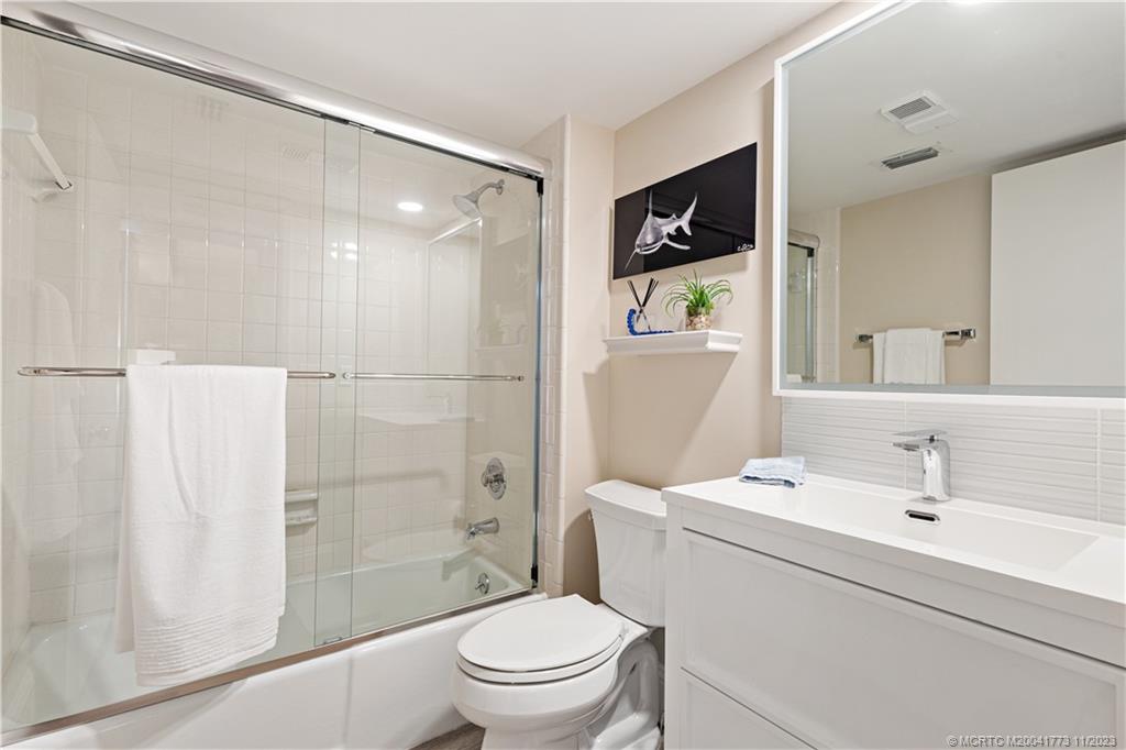 429 Northeast Tradewind Lane, Unit 2109 Stuart, FL 34996 - Photo 25 of 35 a bathroom with a sink toilet and shower