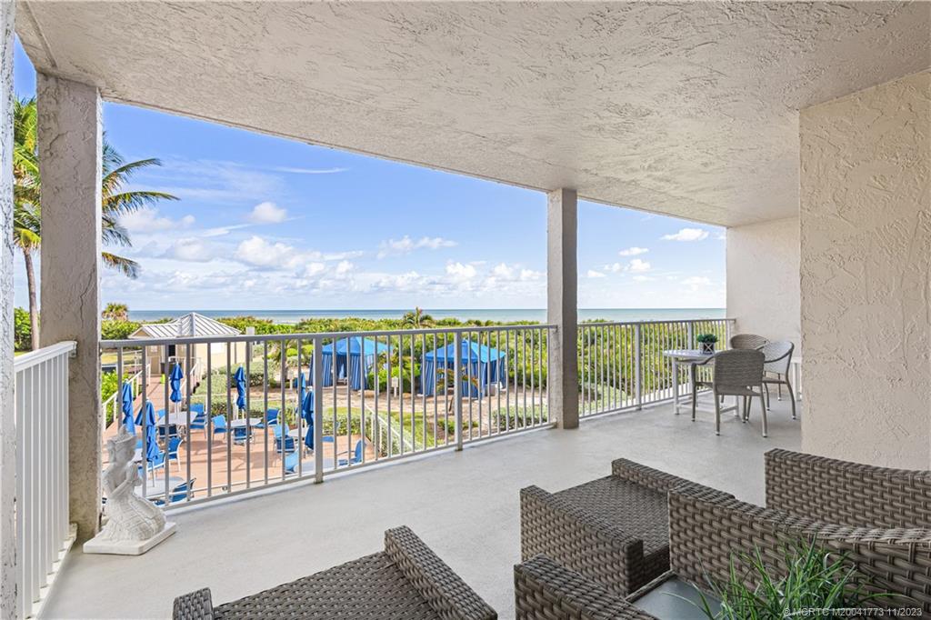 429 Northeast Tradewind Lane, Unit 2109 Stuart, FL 34996 - Photo 26 of 35 a living room with furniture and a floor to ceiling window
