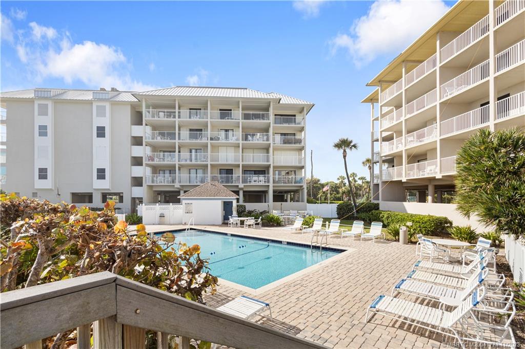 429 Northeast Tradewind Lane, Unit 2109 Stuart, FL 34996 - Photo 32 of 35 a view of a swimming pool with outdoor seating