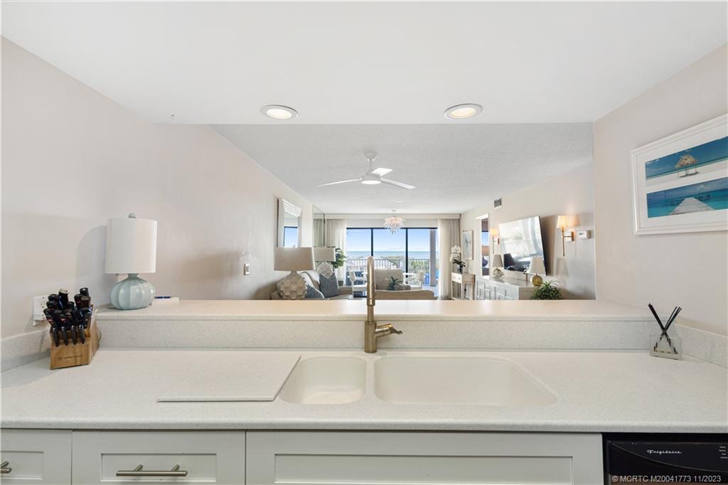 429 Northeast Tradewind Lane, Unit 2109 Stuart, FL 34996 - Photo 10 of 35 a kitchen with a sink and white cabinets