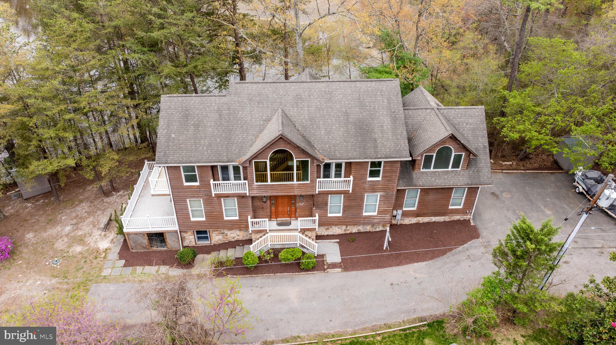 an aerial view of a house with swimming pool and porch