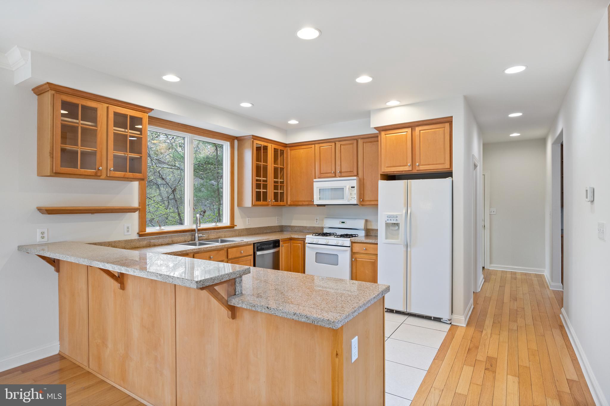 322 Piney Point Road Pasadena, MD 21122 - Photo 14 of 50 a kitchen with stainless steel appliances granite countertop a sink and a refrigerator