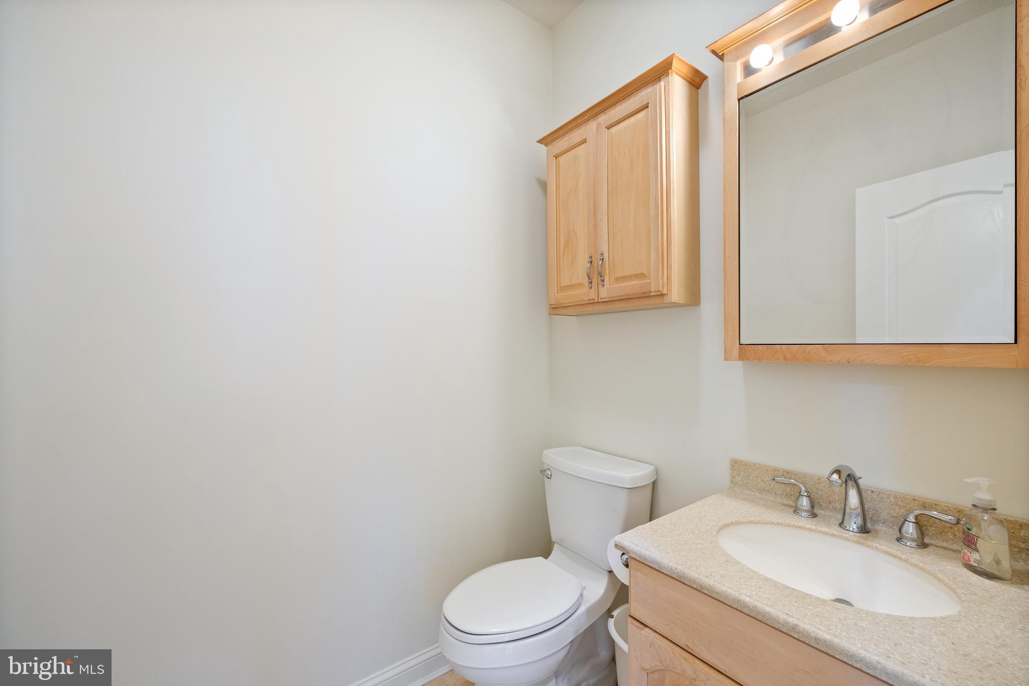 322 Piney Point Road Pasadena, MD 21122 - Photo 17 of 50 a bathroom with a sink a toilet and mirror