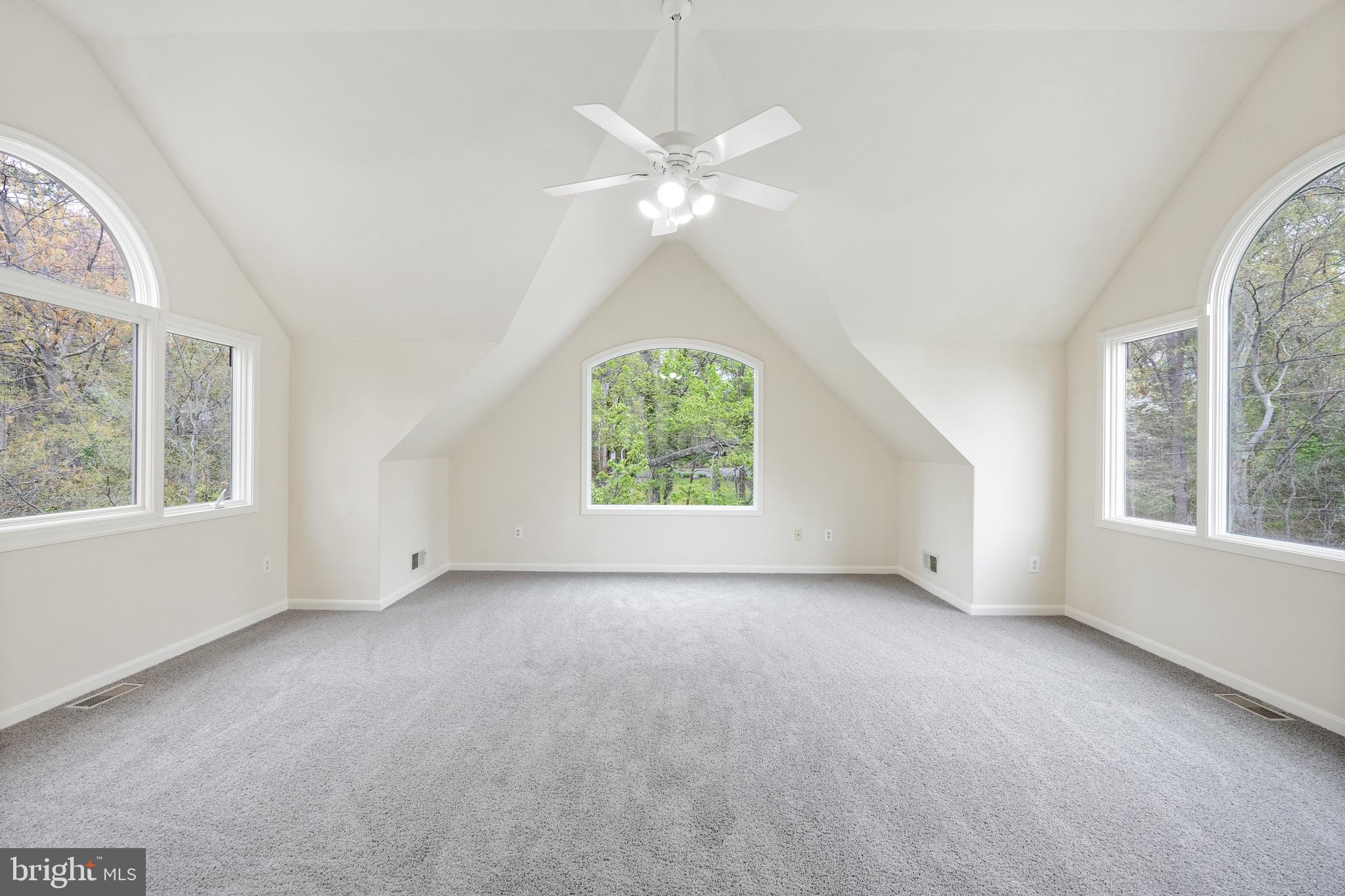 322 Piney Point Road Pasadena, MD 21122 - Photo 24 of 50 an empty room with windows and chandelier fan