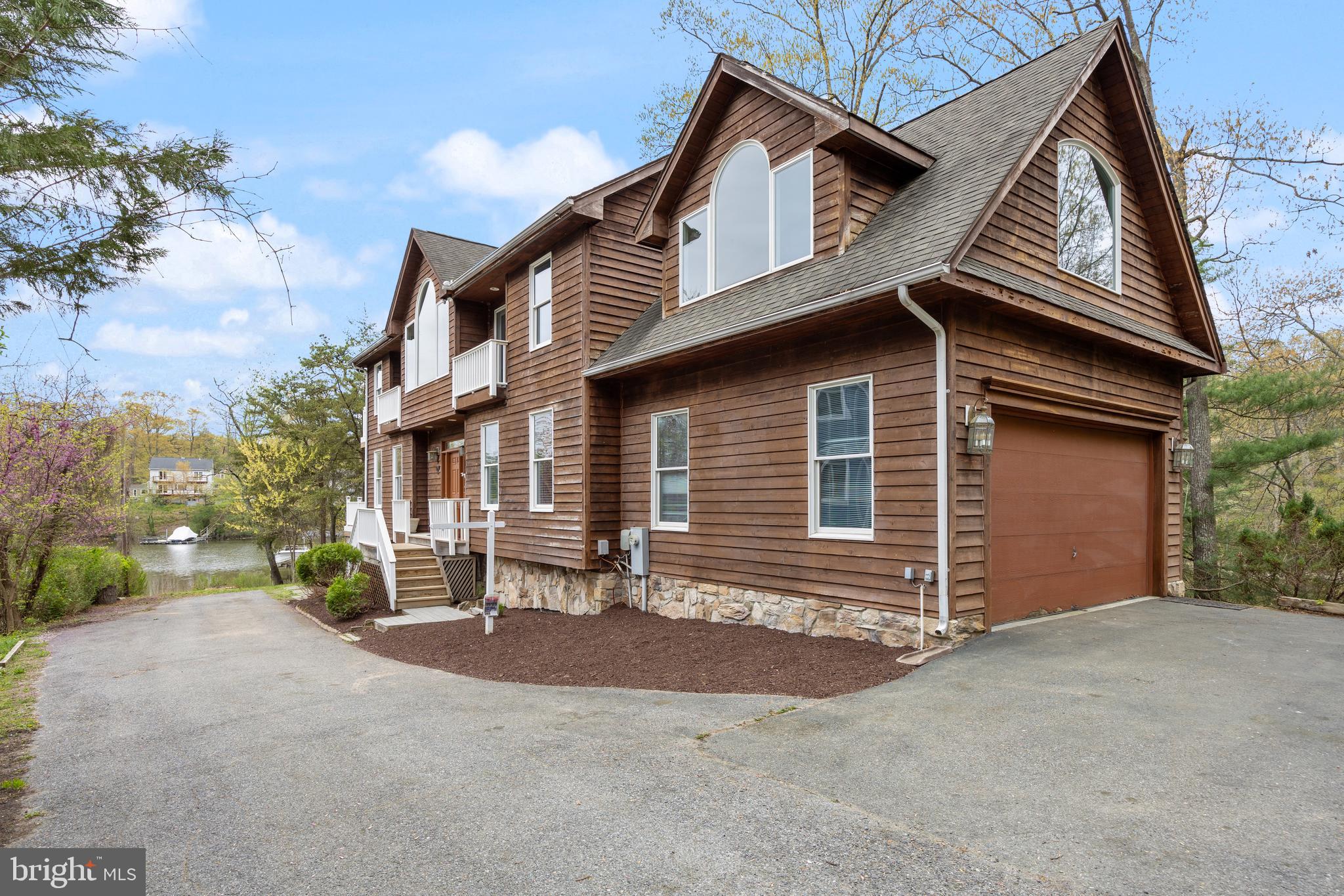 322 Piney Point Road Pasadena, MD 21122 - Photo 3 of 50 a view of a house with a yard and garage