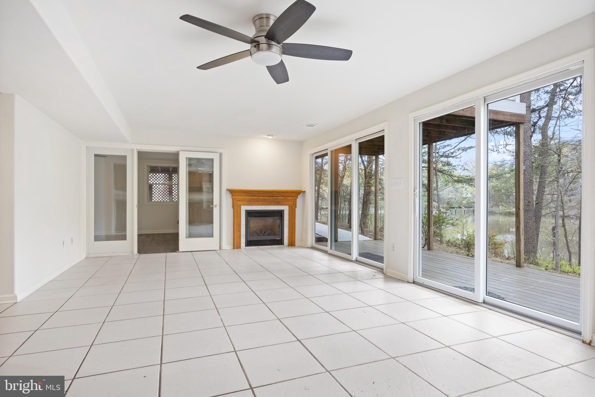 322 Piney Point Road Pasadena, MD 21122 - Photo 34 of 50 a view of an empty room with window and chandelier fan