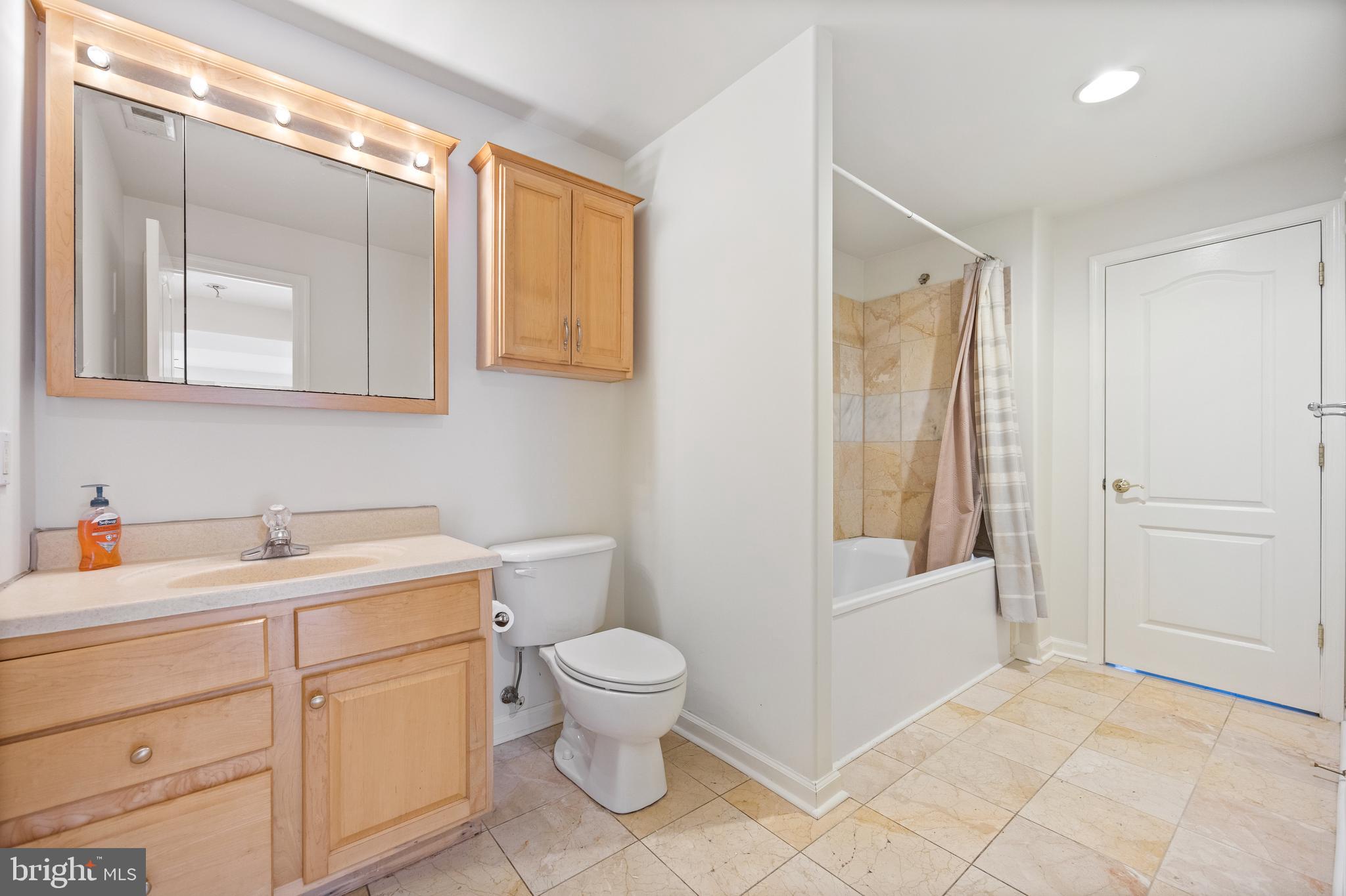 322 Piney Point Road Pasadena, MD 21122 - Photo 35 of 50 a bathroom with a toilet sink and mirror