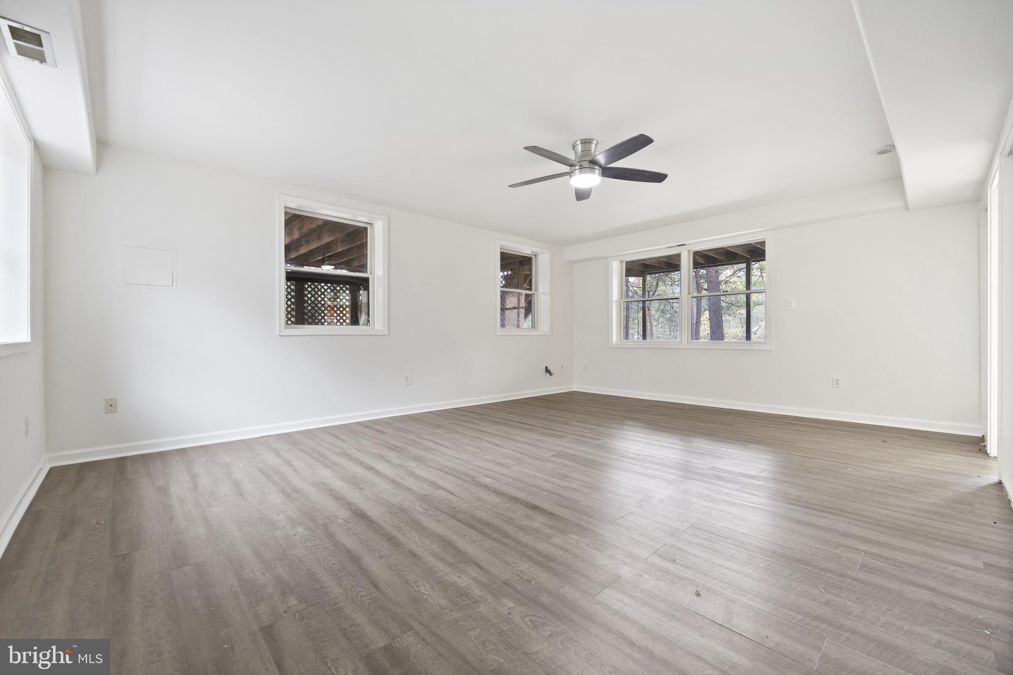 322 Piney Point Road Pasadena, MD 21122 - Photo 36 of 50 a view of empty room with wooden floor and fan