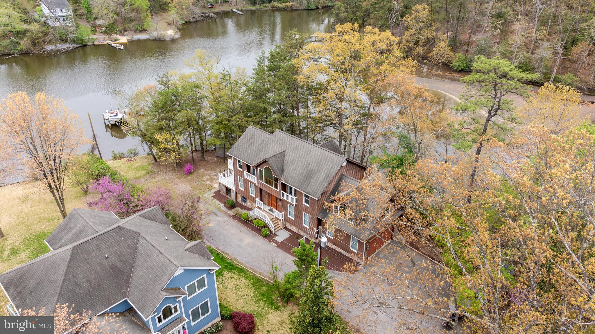 322 Piney Point Road Pasadena, MD 21122 - Photo 4 of 50 an aerial view of a house with a yard and lake view