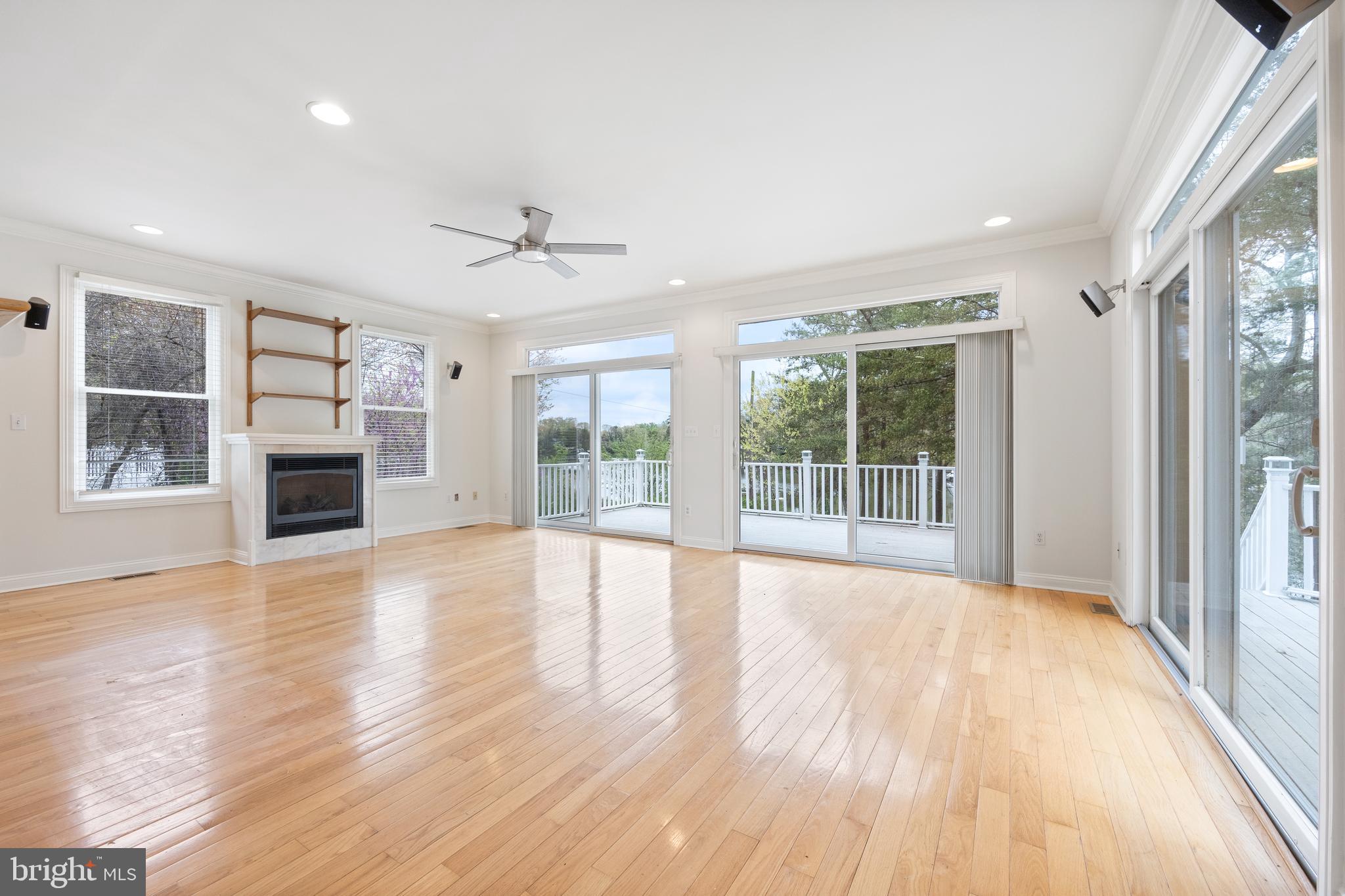 322 Piney Point Road Pasadena, MD 21122 - Photo 7 of 50 a view of an empty room with wooden floor and a window