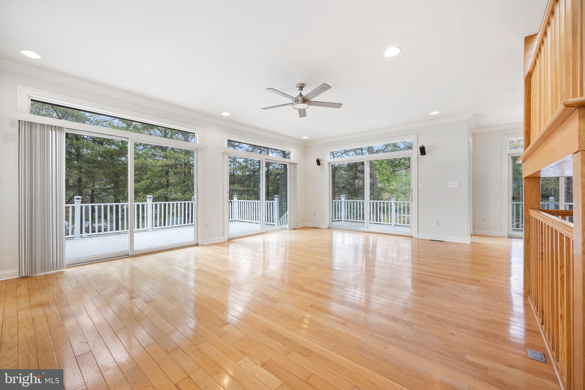 322 Piney Point Road Pasadena, MD 21122 - Photo 8 of 50 a view of an empty room with a window and wooden floor
