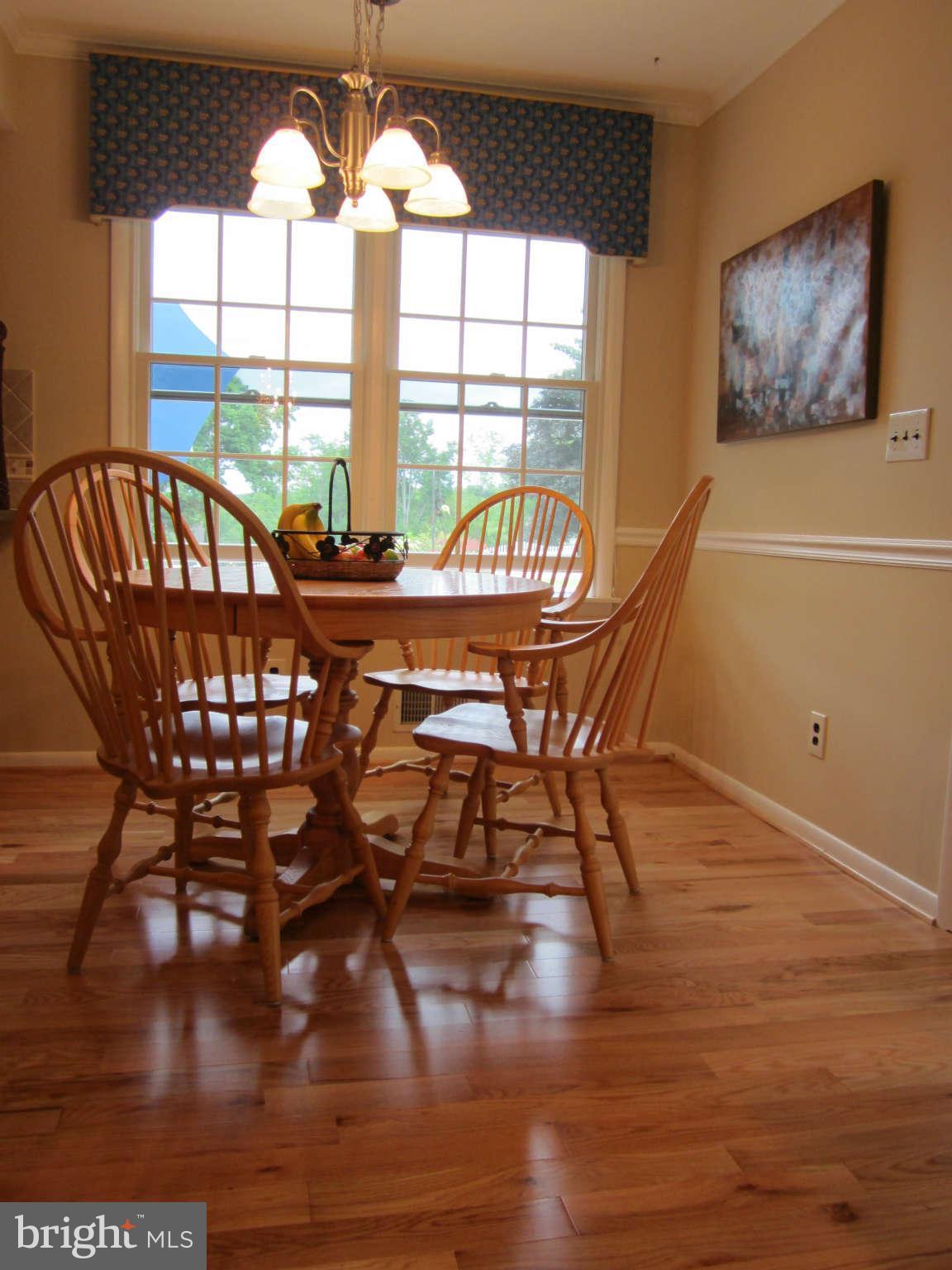 1113 Peachtree Road Fallston, MD 21047 - Photo 11 of 30 a view of a dining room with furniture a chandelier and wooden floor
