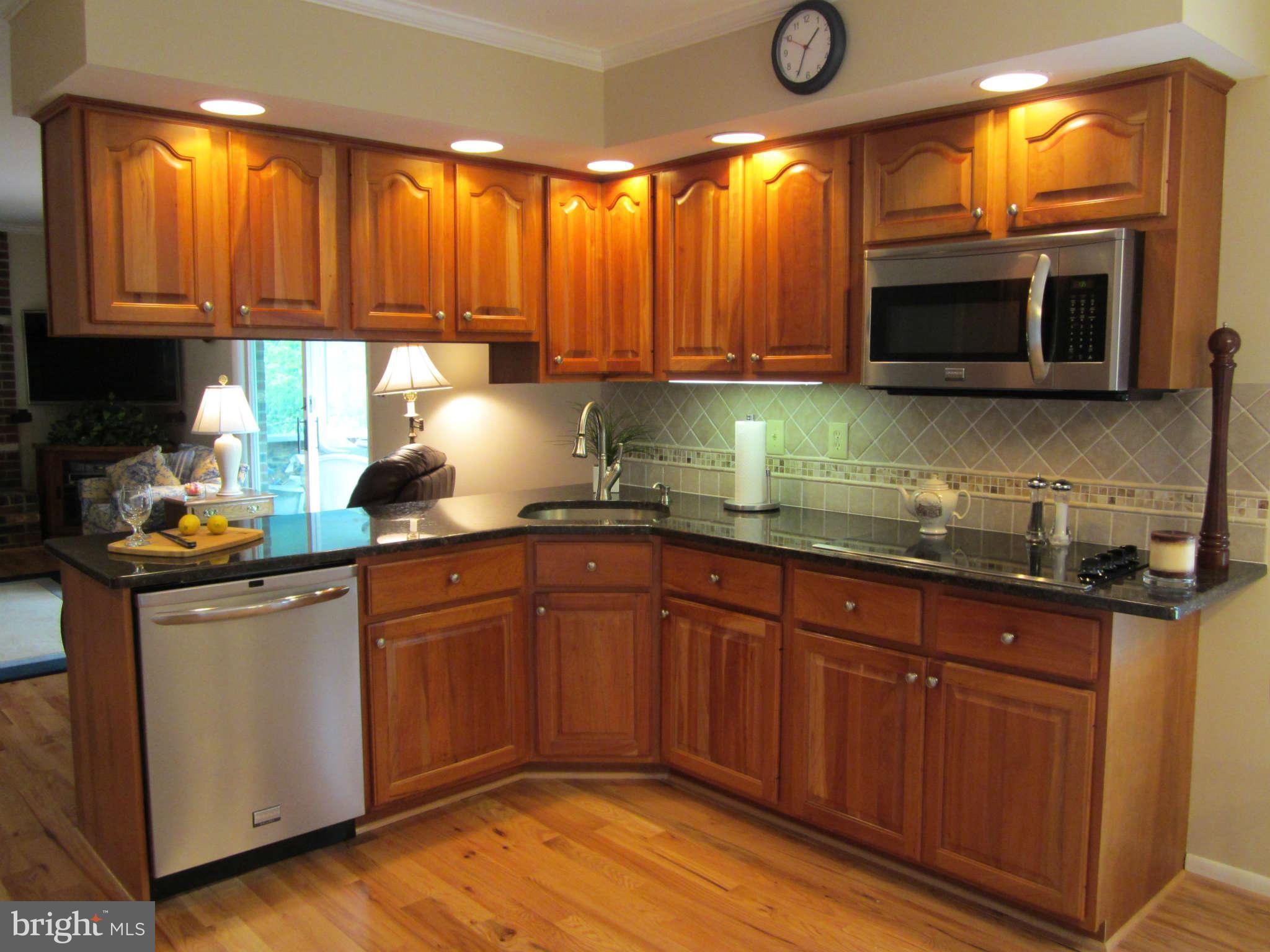 1113 Peachtree Road Fallston, MD 21047 - Photo 12 of 30 a kitchen with stainless steel appliances granite countertop a stove a sink and a microwave