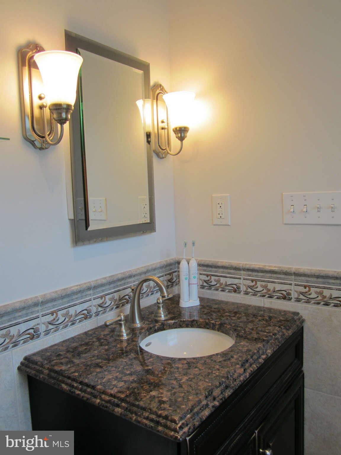 1113 Peachtree Road Fallston, MD 21047 - Photo 22 of 30 a bathroom with a granite countertop sink and a mirror