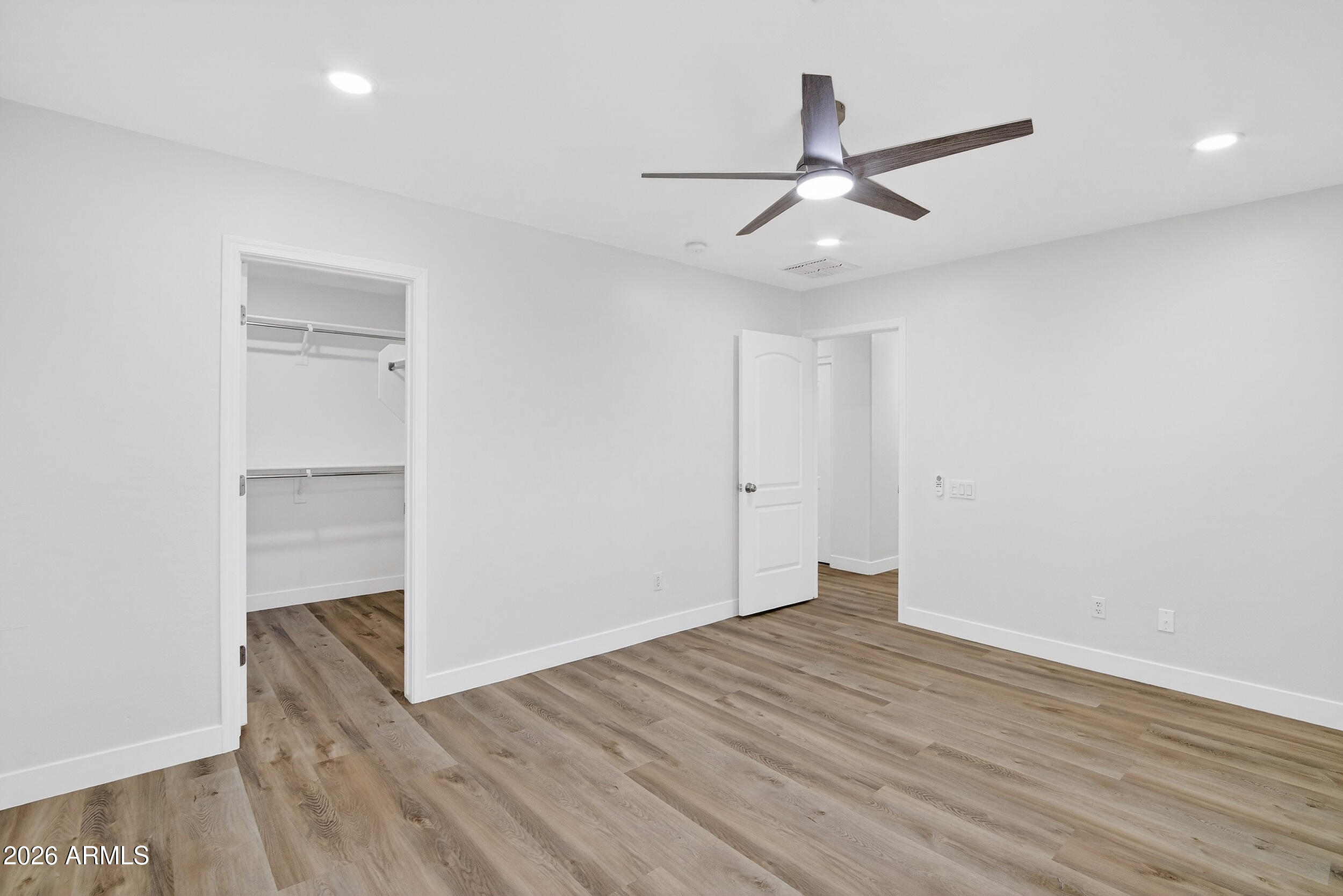 43620 West Cowpath Road Maricopa, AZ 85138 - Photo 43 of 60 wooden floor in an empty room with a window
