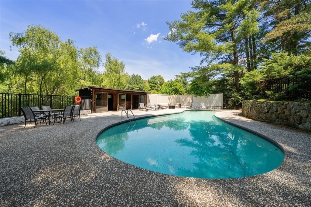 49 Walpole Street Dover, MA 02030 - Photo 37 of 40 a view of a swimming pool with a patio