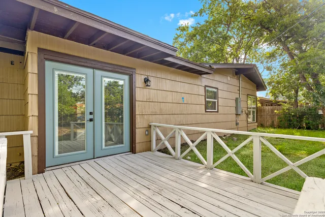 a view of a balcony with wooden floor and outdoor space