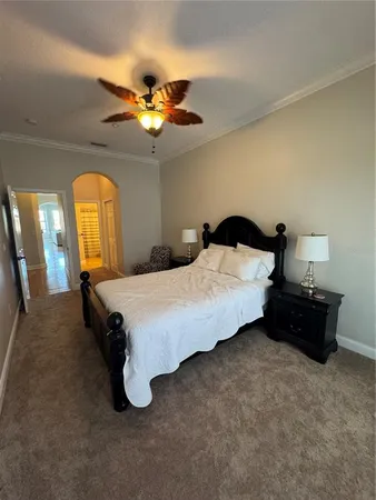 a bedroom with a bed and a chandelier