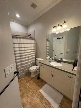 a bathroom with a double vanity sink mirror and toilet