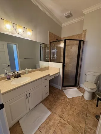 a bathroom with a double vanity sink toilet and mirror