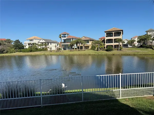 a view of a lake with a house in the background