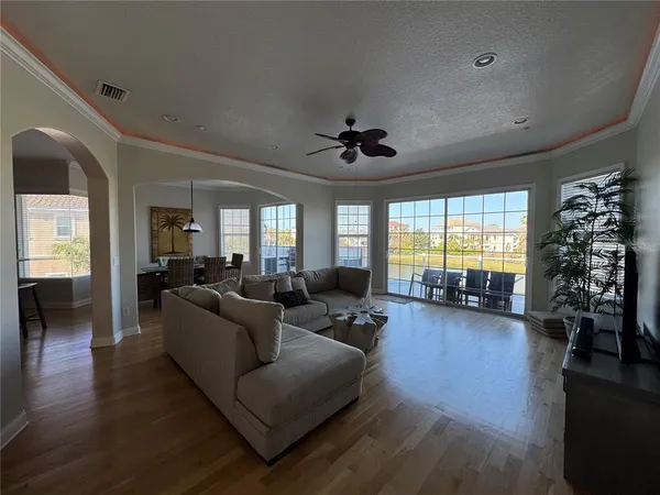 a living room with furniture or wooden floor and a large window