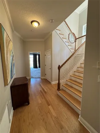 a view of entryway with wooden floor and stairs