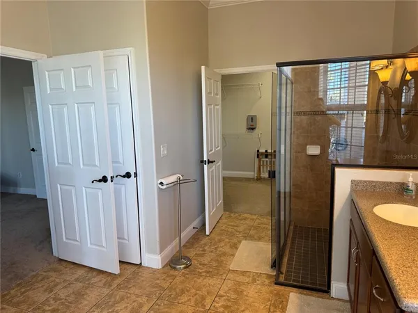 a bathroom with a granite countertop sink and shower