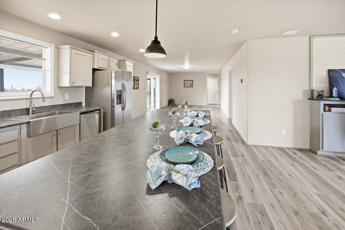 33597 South Davis Ranch Road Marana, AZ 85658 - Photo 12 of 48 a kitchen with stainless steel appliances kitchen island granite countertop a refrigerator and a sink