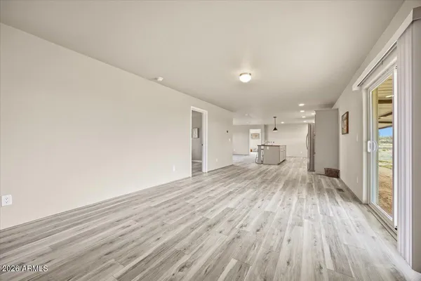 a view of a room with wooden floor and furniture