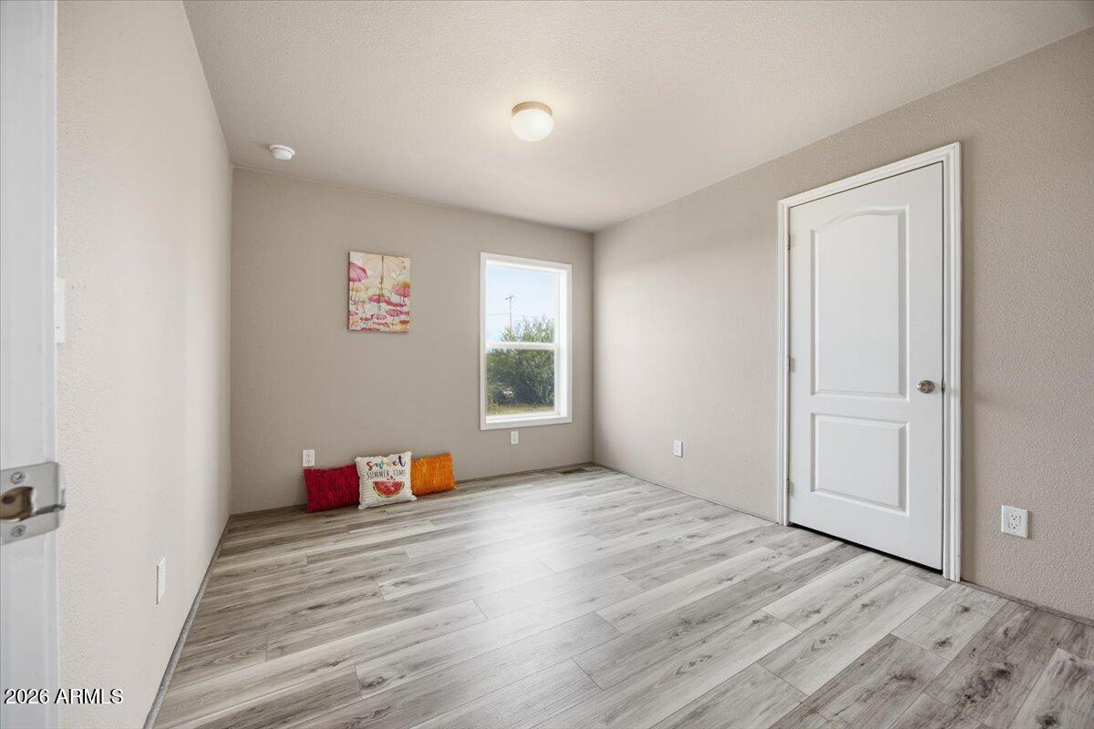 33597 South Davis Ranch Road Marana, AZ 85658 - Photo 30 of 48 an empty room with wooden floor and window