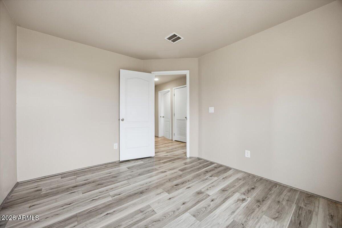 33597 South Davis Ranch Road Marana, AZ 85658 - Photo 32 of 48 a view of an empty room with wooden floor