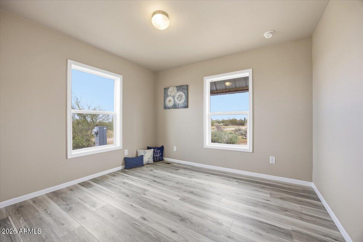 33597 South Davis Ranch Road Marana, AZ 85658 - Photo 33 of 48 a view of an empty room with wooden floor and a window