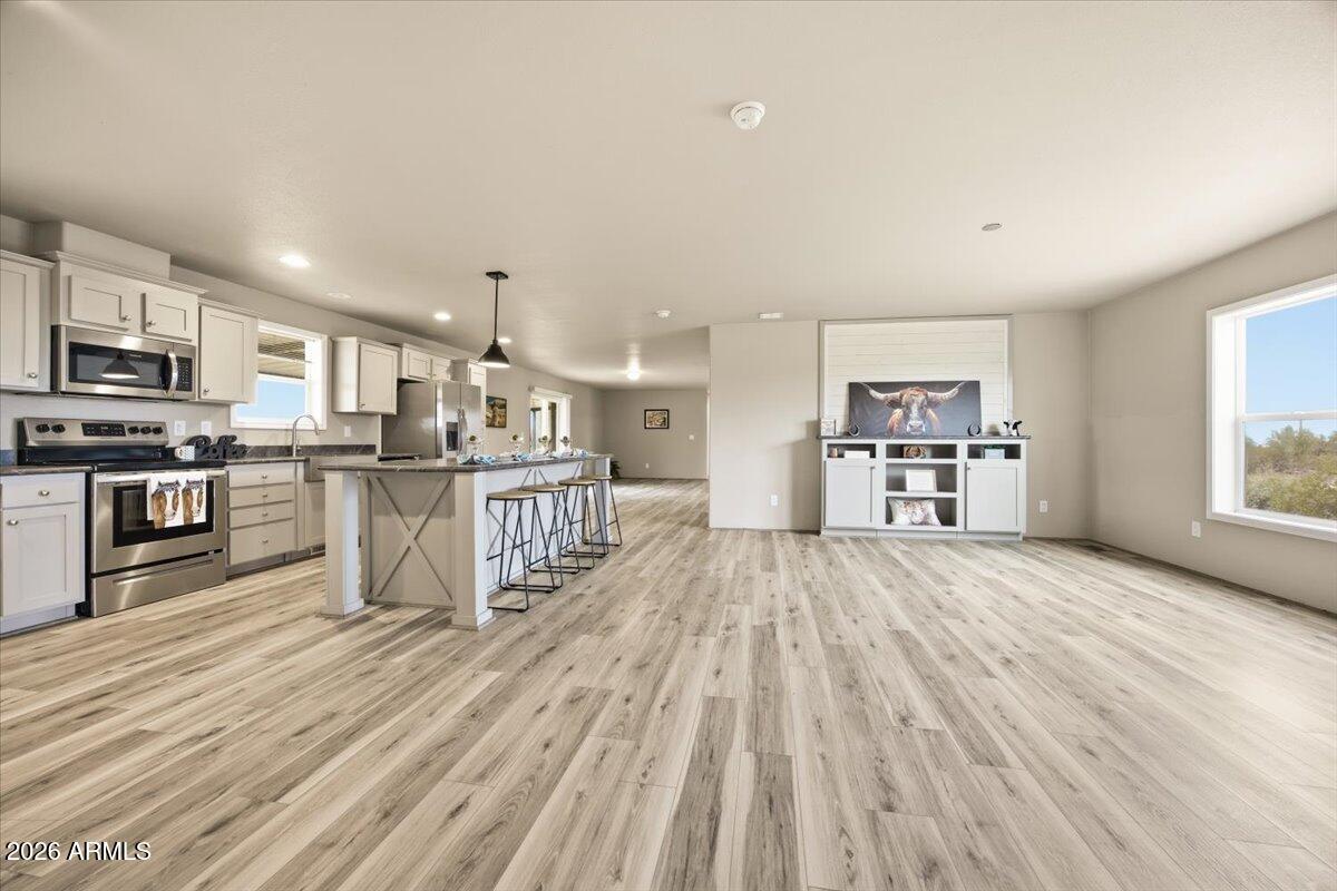 33597 South Davis Ranch Road Marana, AZ 85658 - Photo 7 of 48 a view of kitchen with microwave a stove and wooden floor