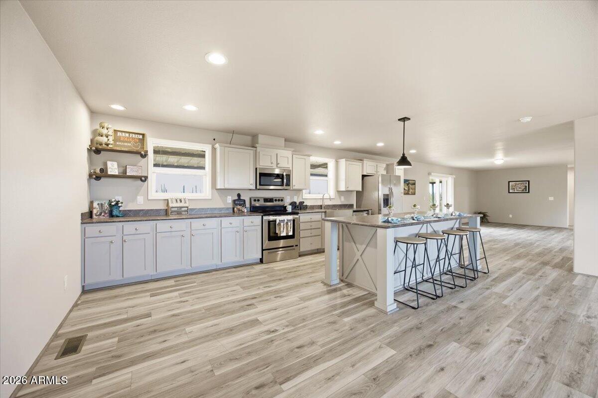 33597 South Davis Ranch Road Marana, AZ 85658 - Photo 10 of 48 a large kitchen with a center island and wooden floor