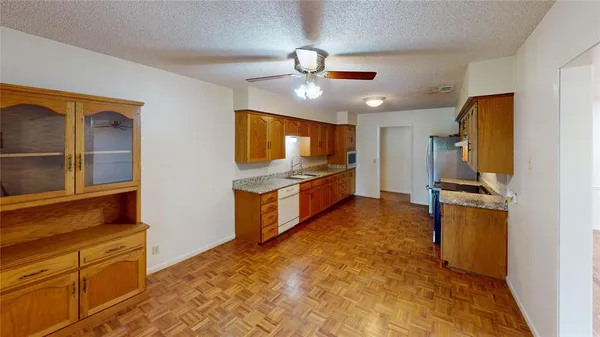 a kitchen with stainless steel appliances a refrigerator and a stove top oven