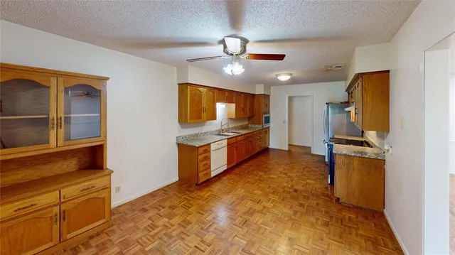 a kitchen with stainless steel appliances a refrigerator and a stove top oven