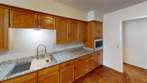 a kitchen with stainless steel appliances granite countertop a sink and cabinets